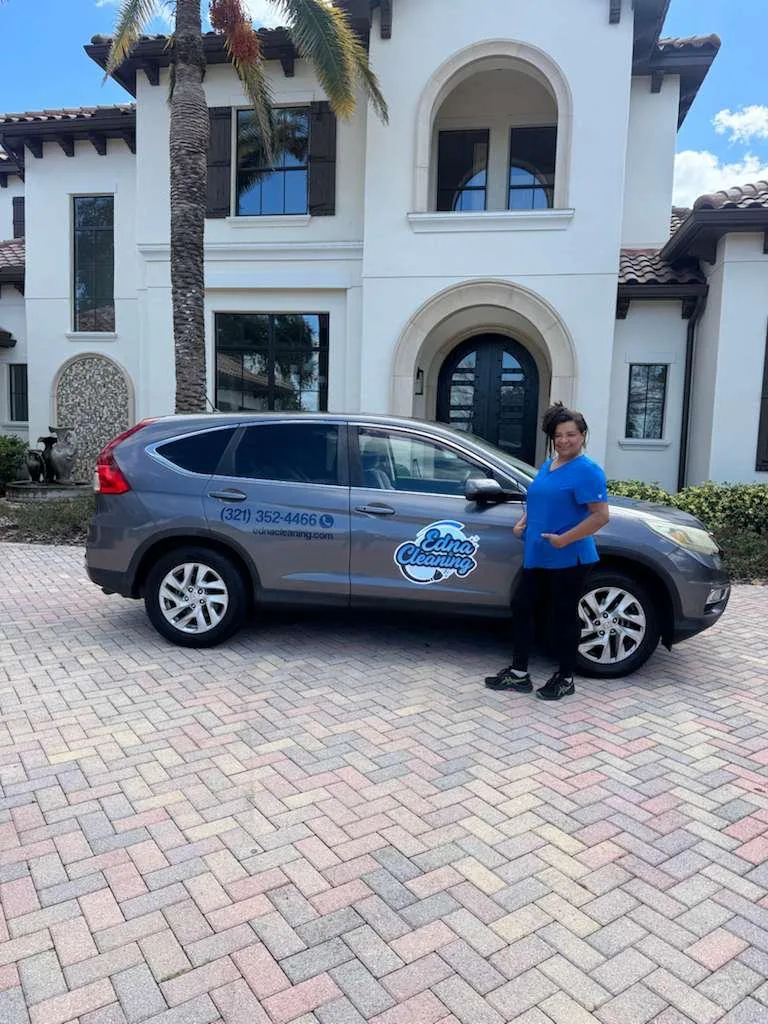 Edna Cleaning Services team member standing beside the company's branded cleaning van